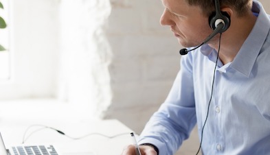 Man using GoToConnect and headset for phone calls