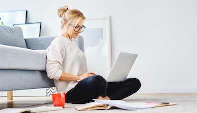 Remote worker working on laptop from living room