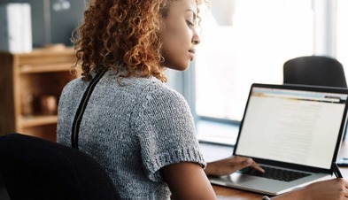 Woman on laptop working.