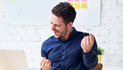 Man celebrating after running a successful webinar