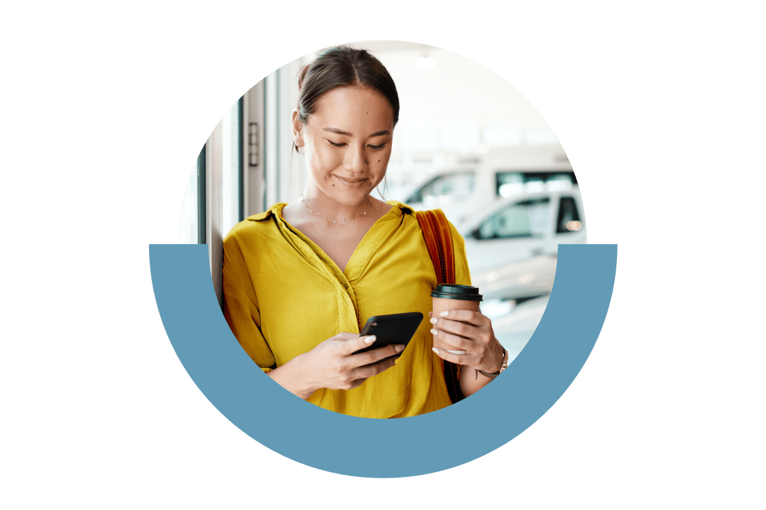 Person confidently reviewing administrative tasks on their cell phone at a car dealership.